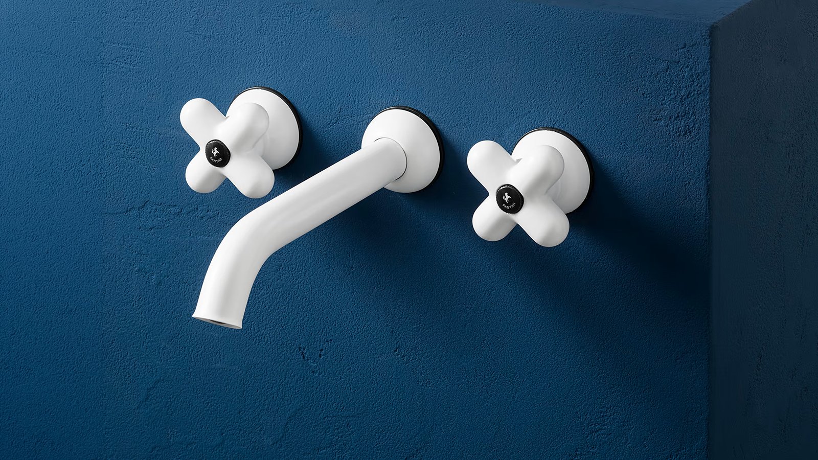 I Balocchi three-hole lavatory faucet by Fantini, red with chrome, on a blue sink