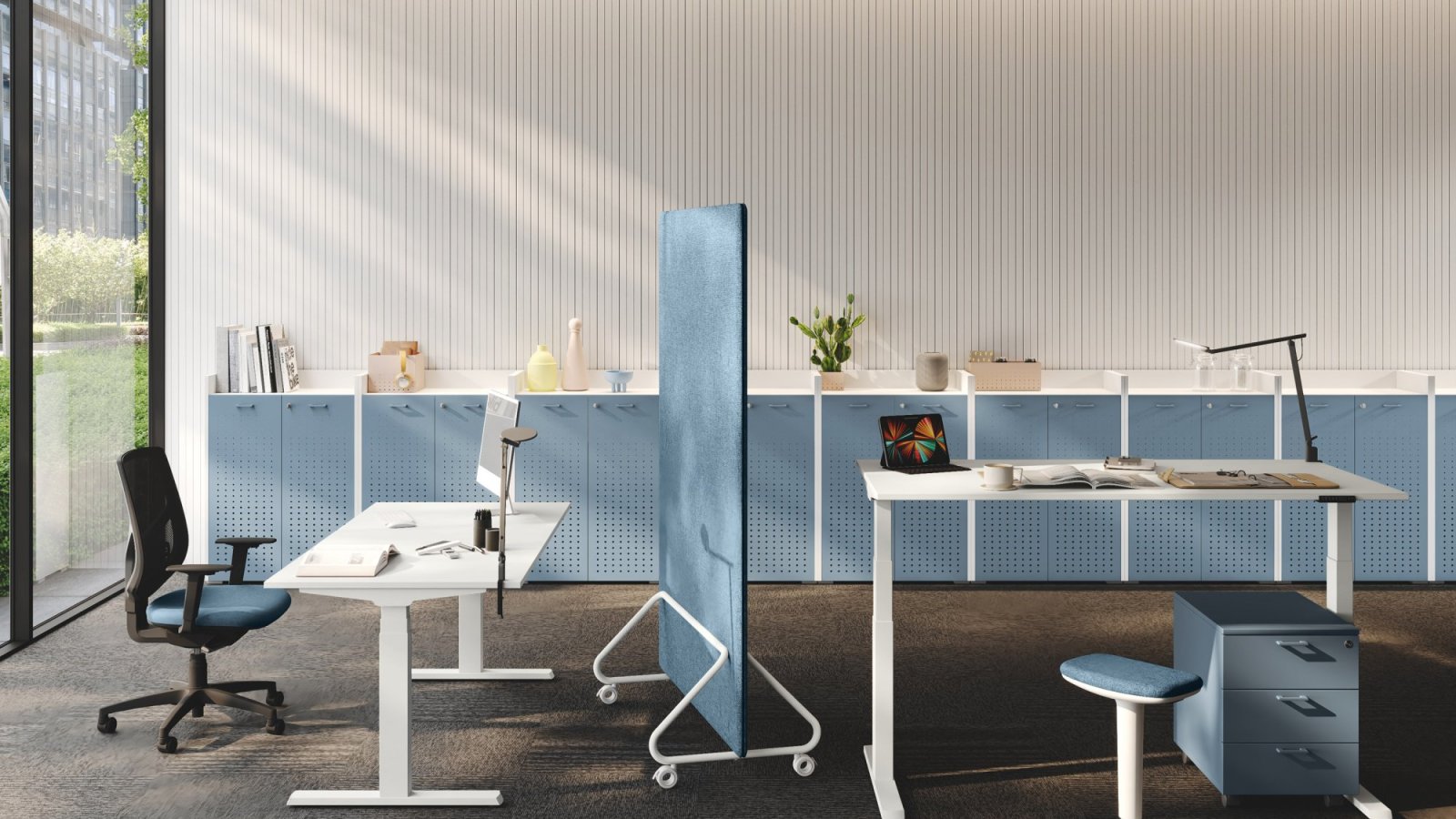 UP sit-stand operative desk by Las Mobili raised to standing height with black T legs