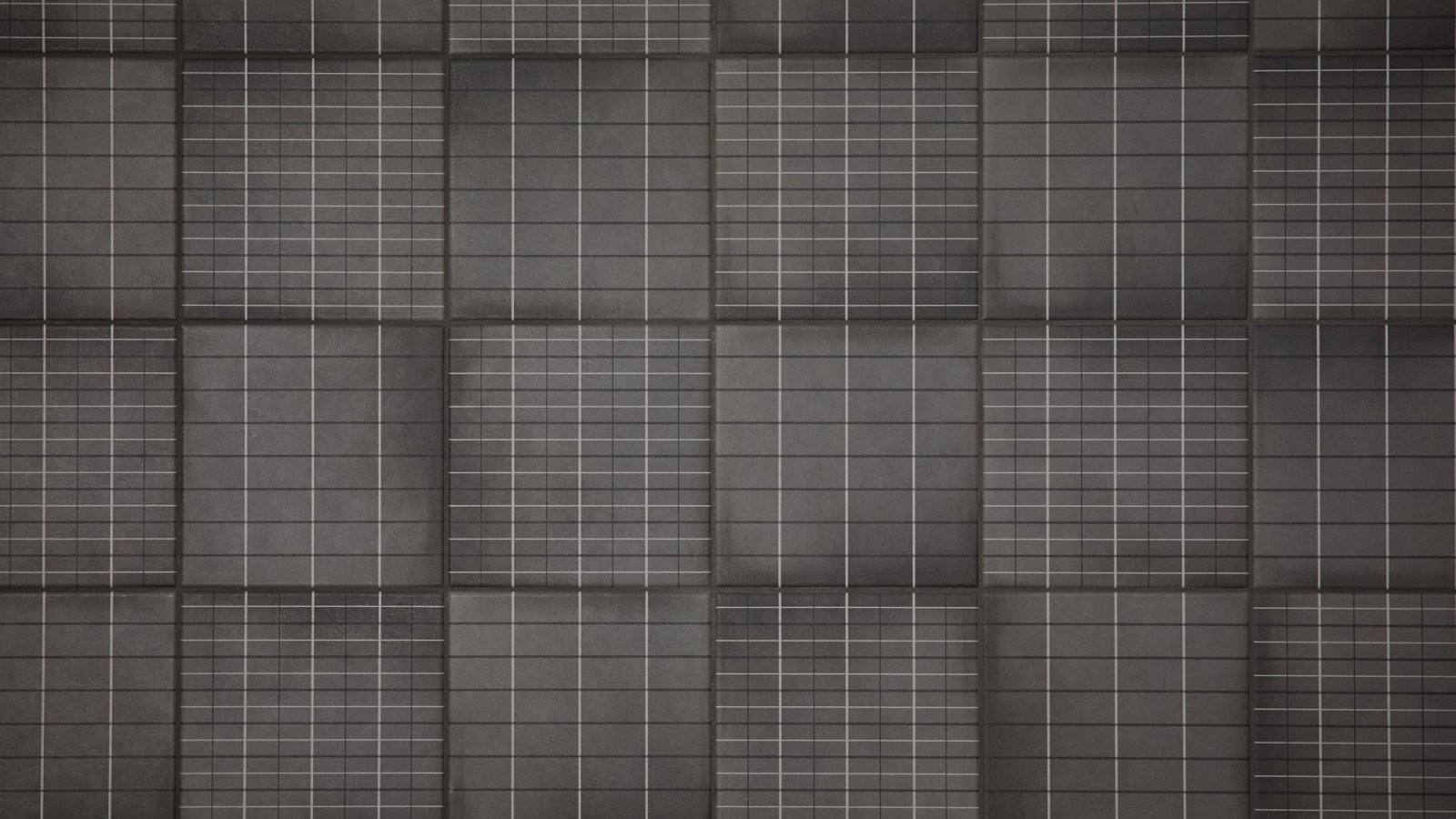 Executive washroom wall in Aurore Charcoal Grid L porcelain by Mutina