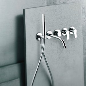 Wall-mount AL/23 lavatory faucet, its curved spout and its lever each on a round escutcheon