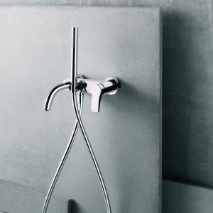 Tall AL/23 faucet by Fantini set beside a stone vessel sink