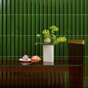 Round lobby column clad in Rombini ceramic battens by Mutina