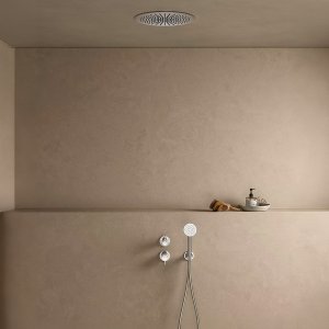 Floor-mount Flora tub filler by Fantini next to a freestanding tub