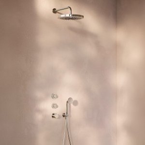 Flora hand shower by Fantini resting in its wall-mounted holder