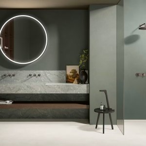 Shower wall with Flora valves stacked vertically below a round showerhead