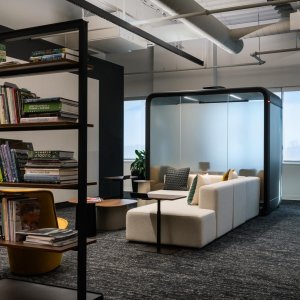 Black Framery Four pod next to workstation clusters