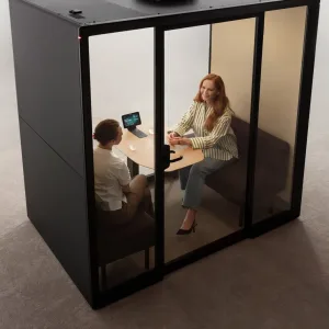 Four people meeting inside the Framery Gradus Huddle pod