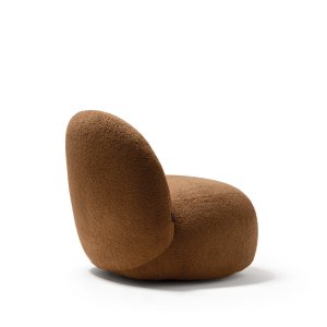 Writing table with a walnut top standing next to a Hill armchair