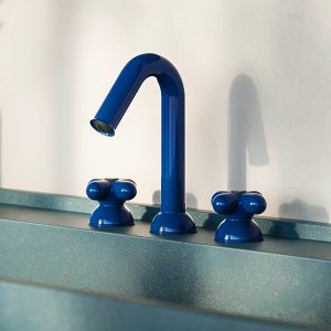 Side view of the red arched spout on a Fantini I Balocchi faucet