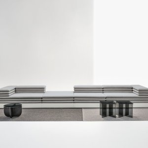 Acamante 2-seat sofa, its base wrapped in fabric that matches the cushions