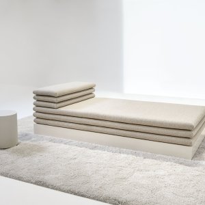 Layered flat cushions making up the backrest and armrest on Acamante
