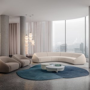 Profile of the Apper armchair showing the low back wrapping into the arm
