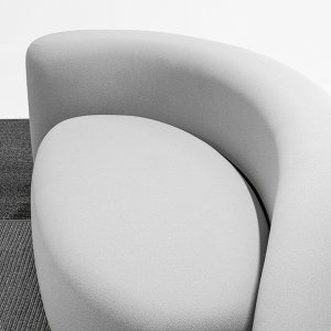 Stretch upholstery wrapping the rounded edge of a Lisse sofa, close-up
