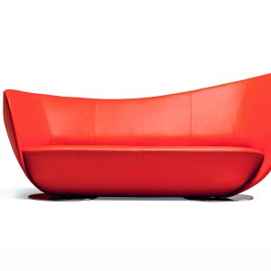 Angled view of the LaCividina sofa resting on two round chrome discs