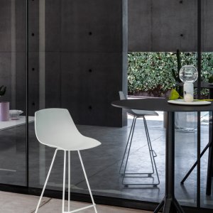 Miunn sled-base chair beside a table