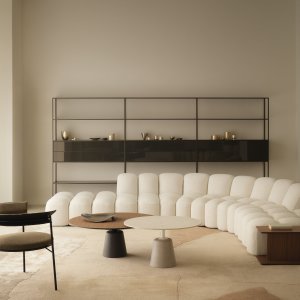 Curved Array pouf placed against the backrest modules