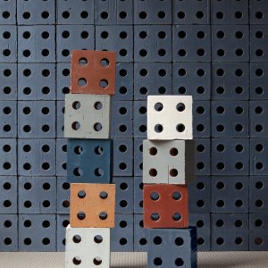 Colorful Bloc block towers against a Bloc Blue wall