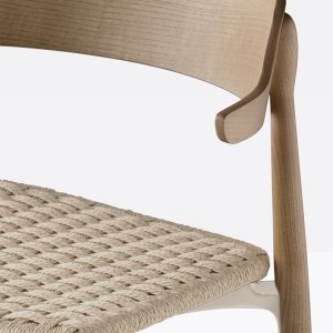 Shaped ash backrest of the Nemea resting on the table
