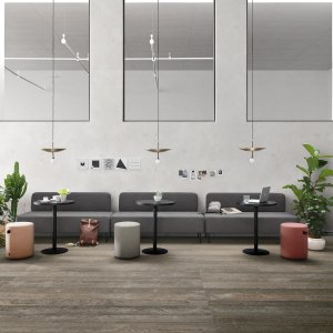 Nucleo sofa and poufs beside Pigreco workstations