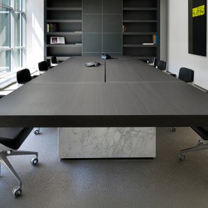 Black lacquered cabinet under a light oak top on the Asymmetrical desk
