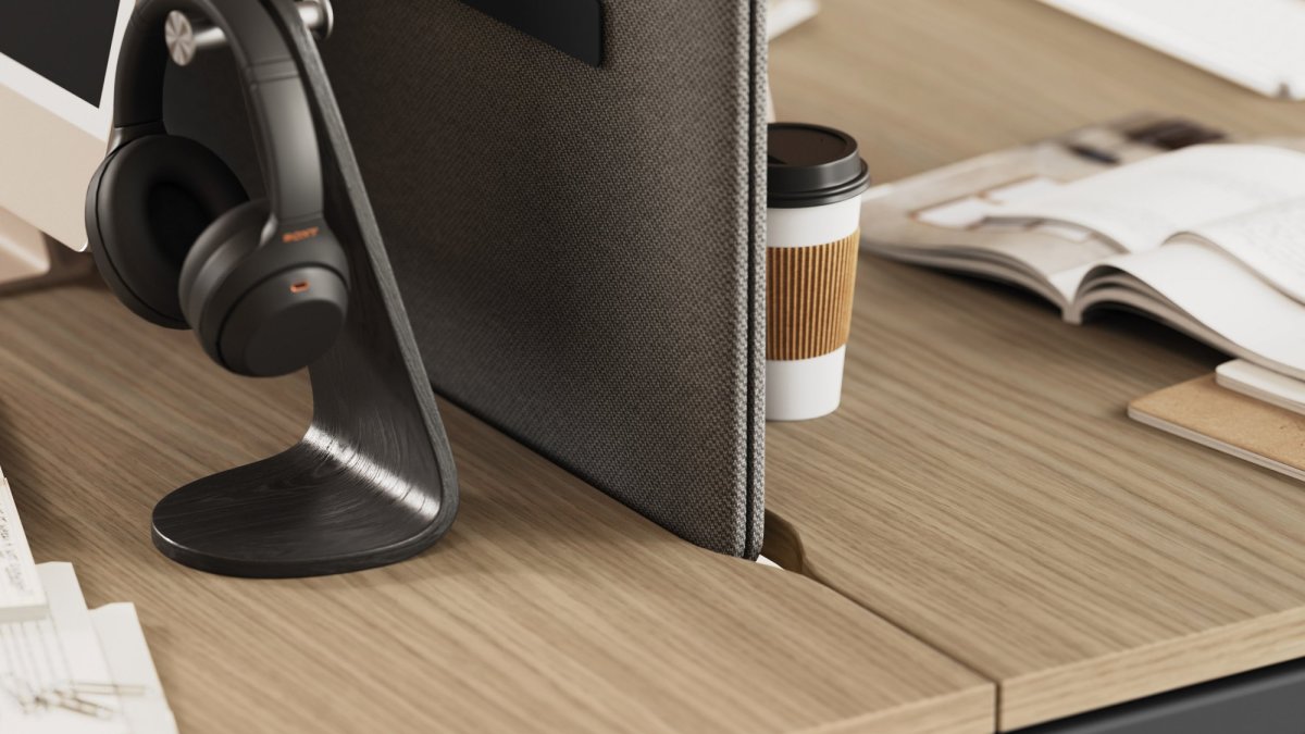 Close-up of the Las Mobili Sigma workstation: wood-effect top and fabric desk screen