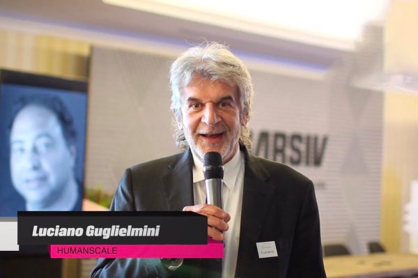 Luciano Guglielmini of Humanscale speaking into a microphone at an event