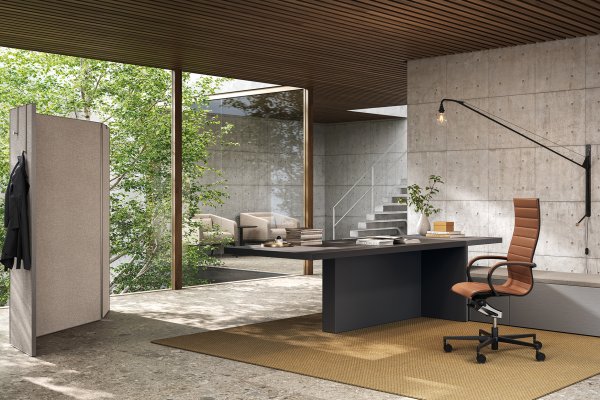 Frezza Mux70 executive desk with a tan leather chair in an office of concrete and wood
