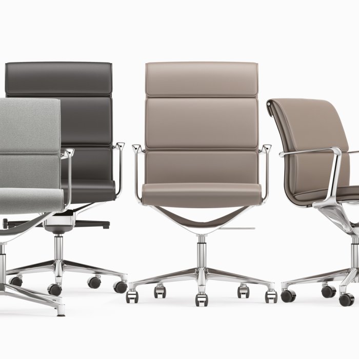 High-back Italian leather executive chair behind a walnut desk in a Manhattan corner office, viewed from the visitor's seat